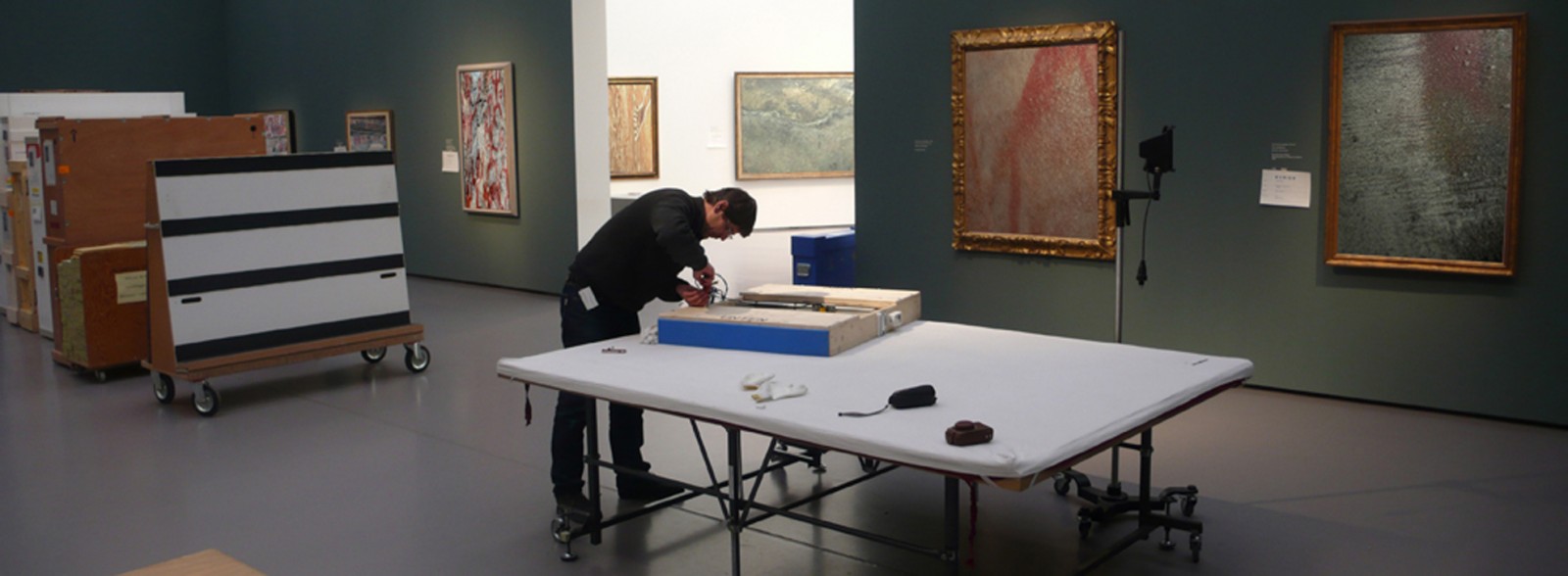 Man packs art painting in museum