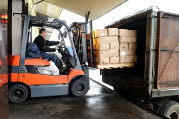 Forklift driver loading cartons